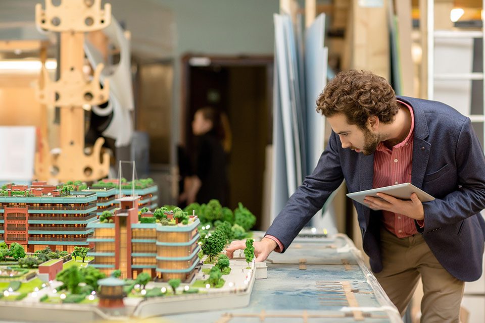 Architect looking at model in front of him